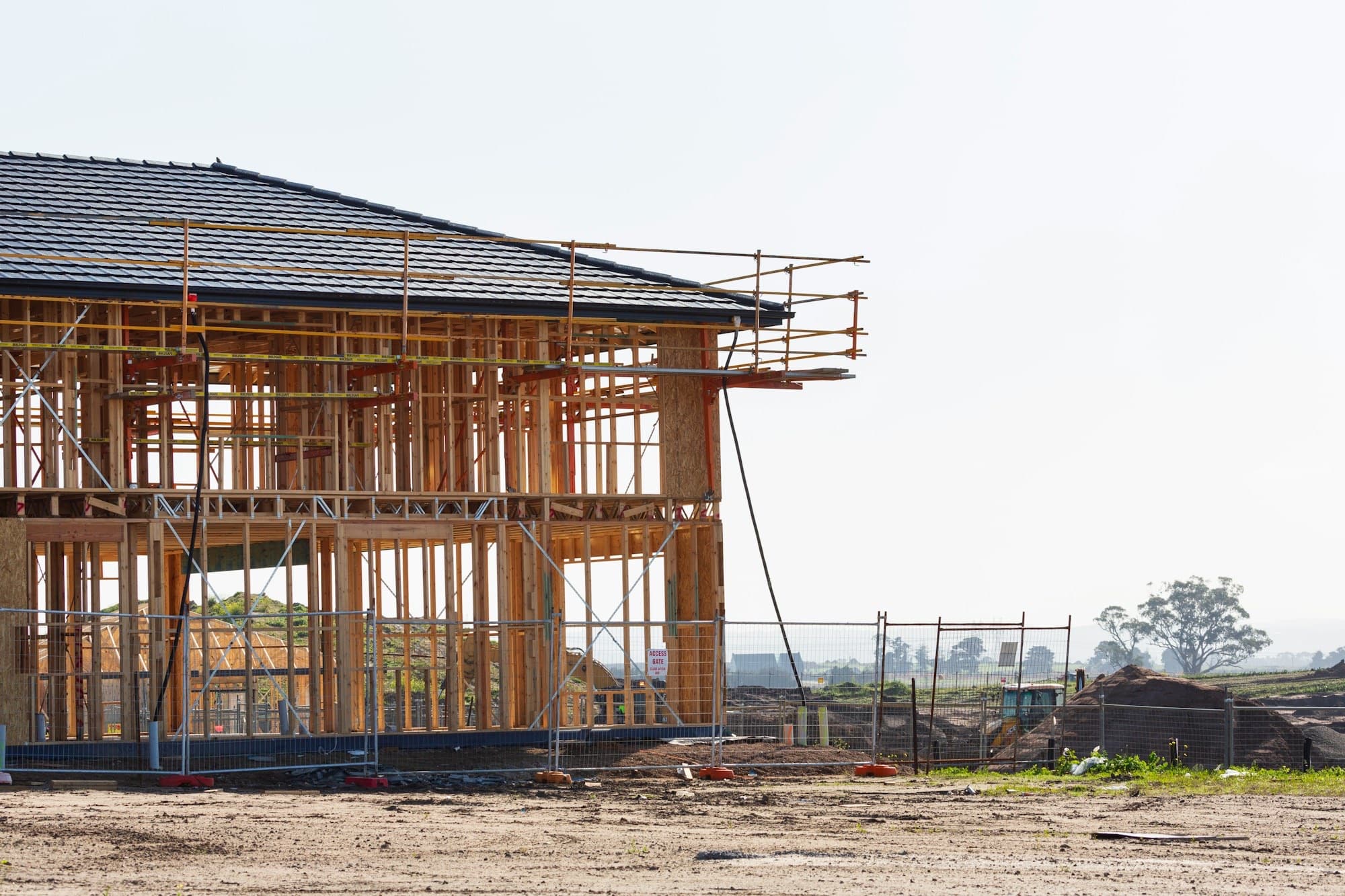 Home under construction, framed and wrapped in scaffolding