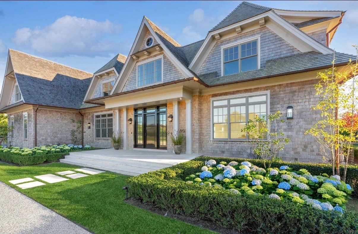 Cedar shingle home with a hydrangea garden and stepping-stone lawn