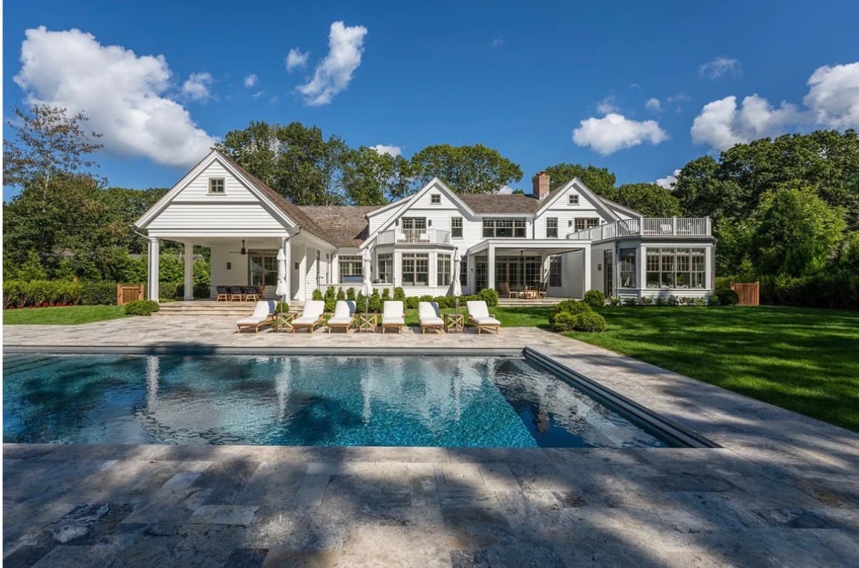 Shingle-style estate with a pool and stone terrace